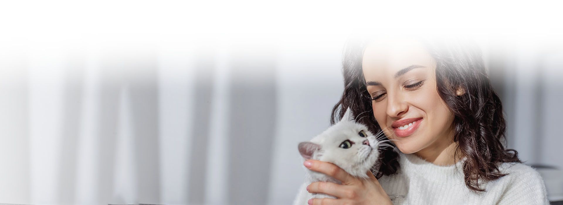 woman hugging her white cat